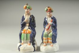 A PAIR OF STAFFORDSHIRE FIGURES OF TURKS. 7.5ins high.