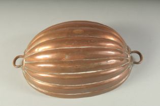 A TWO HANDLED COPPER MELON SHAPED JELLY MOULD. 10.5ins x 8ins.