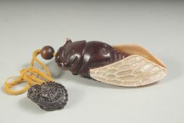 A CARVED HARDWOOD AND MOTHER-OF-PEARL FLY INRO on a string. 4.5ins.