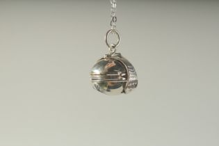 A SILVER OPENING BALL PENDANT on a chain, boxed.