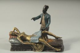 A PAINTED CAST IRON EROTIC BRONZE. 7ins high.