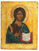 A 19TH CENTURY RUSSIAN ICON, holding a book. 26cms x 20cms.