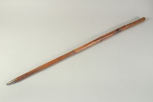 AN EARLY WOODEN CASED SWORD STICK with engraved blade. 3ft long.