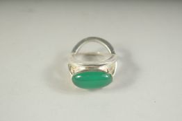 A SILVER AND JADE RING.