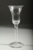 A GEORGIAN WINE GLASS with inverted bell bowl and white twist stem. 6.75ins high.
