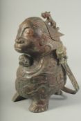 A CHINESE BRONZE ARCHAIC ETHNIC CENSER with swing handle. 12ins high,