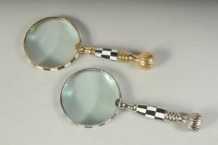 TWO MAGNIFYING GLASSES with chequered and metal handles.