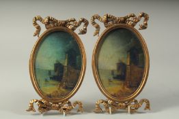 A PAIR OF OVAL PICTURES in gilt frames.