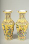 A PAIR OF CHINESE YELLOW GROUND OCTAGONAL VASES. 11ins high.