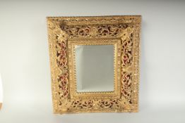 A SUPERB ITALIAN CARVED AND GILDED MIRROR. 24ins x 22ins.