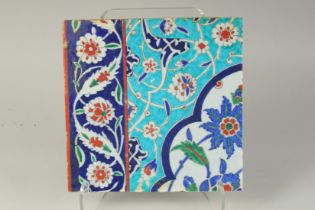 AN OTTOMAN TURKISH GLAZED POTTERY TILE, 27.5cm square.