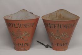 A PAIR OF RED CHATEAUNEUF-DU-PAPE GRAPE CARRIERS.