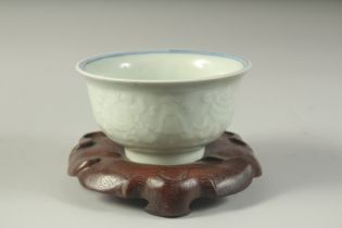A CHINESE CELADON GROUND BLUE AND WHITE PORCELAIN BOWL, with carved decoration and characters, the