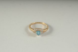 A 9CT GOLD BLUE TOPAZ AND DIAMOND RING, boxed.