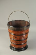 A GOOD DUTCH WOODEN RIBBED TAPERING PAIL with brass handles. 13ins high.