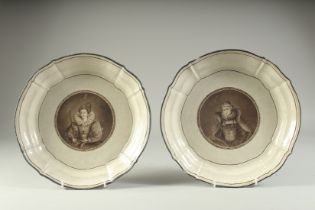 A PAIR OF 18TH CENTURY CIRCULAR PORTRAIT PLATES of Queens. 10.5ins diameter.