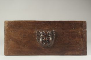 AN 18TH CENTURY CARVED WOOD CHERUB HEAD on a marble plaque. 20ins long.
