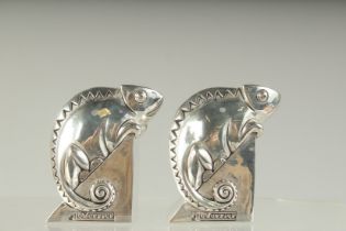 A PAIR OF SILVER PLATE DECO CHAMELEON SALT AND PEPPERS. 8cms high.