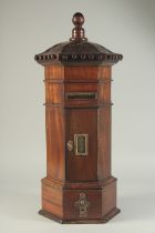 A SMALL GEORGIAN STYLE MAHOGANY OCTAGONAL POST BOX with brass letter flap, panel door and small