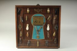 A COLLECTION OF ESCUTCHEONS AND KEYS, mounted on a frame. 17ins x 17ins.