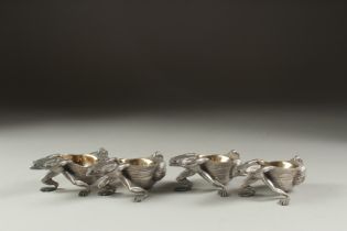 A GOOD SET OF FOUR SILVER PLATED FROG SALTS with gilt interiors.
