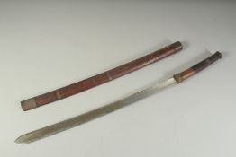 A BURMESE CURVING SWORD in a metal banded sword. 30ins long.