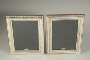A PAIR OF SILVER PHOTOGRAPH FRAMES. 9ins x 7ins.
