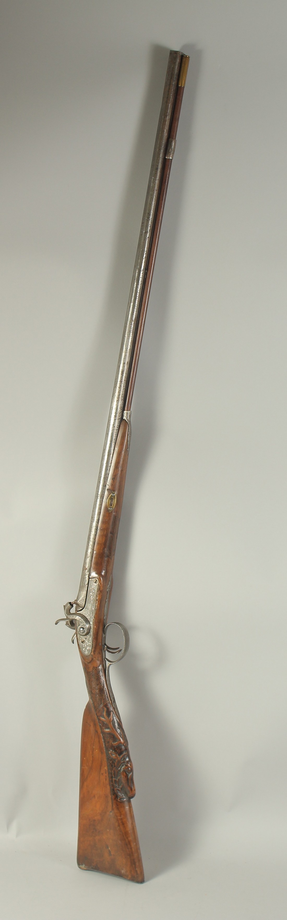 A GERMAN DOUBLE BARRELLED PERCUSSION SPORTING GUN, 18 bore with well carved stock depicting a deer.