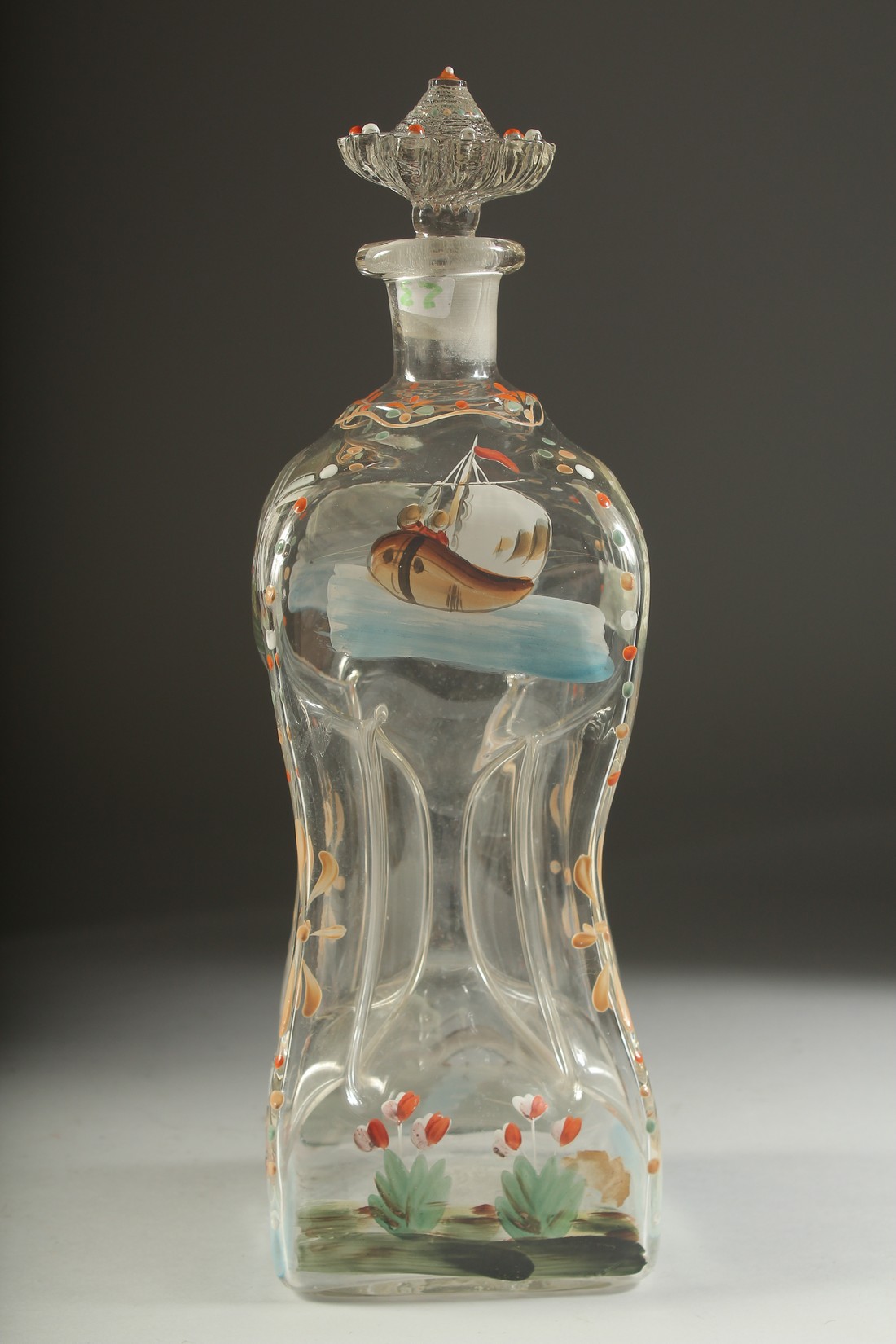 A VICTORIAN FOUR DIVISION DECANTER AND STOPPER, painted with ducks and a windmill etc. 14ins high.