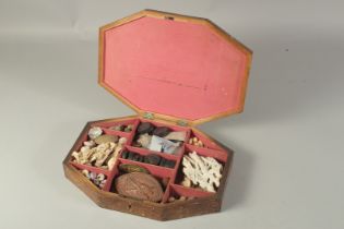 A BOX OF GEORGIAN SHELLS AND BADGES in a wooden box.