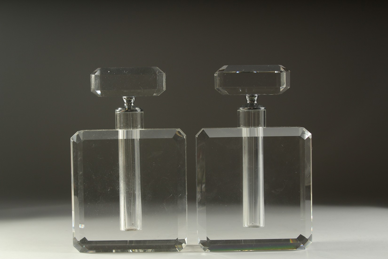 A PAIR OF HEAVY GLASS SCENT BOTTLES AND STOPPERS. 10ins high.