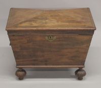 A REGENCY MAHOGANY CELLARETTE IN THE MANOR OF THOMAS HOPE with rising top, brass ring carrying