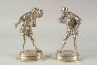 A GOOD PAIR OF HEAVY, SILVERED METAL FIGURES on oval bases. 8.5ins high.