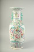 A LARGE CHINESE PORCELAIN CANTON VASE with panels of figures and flowers. 23ins high.