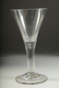 A LARGE PLAIN GEORGIAN WINE GLASS with tapering bowl, tear drop and heavy stand. 8.25ins high.
