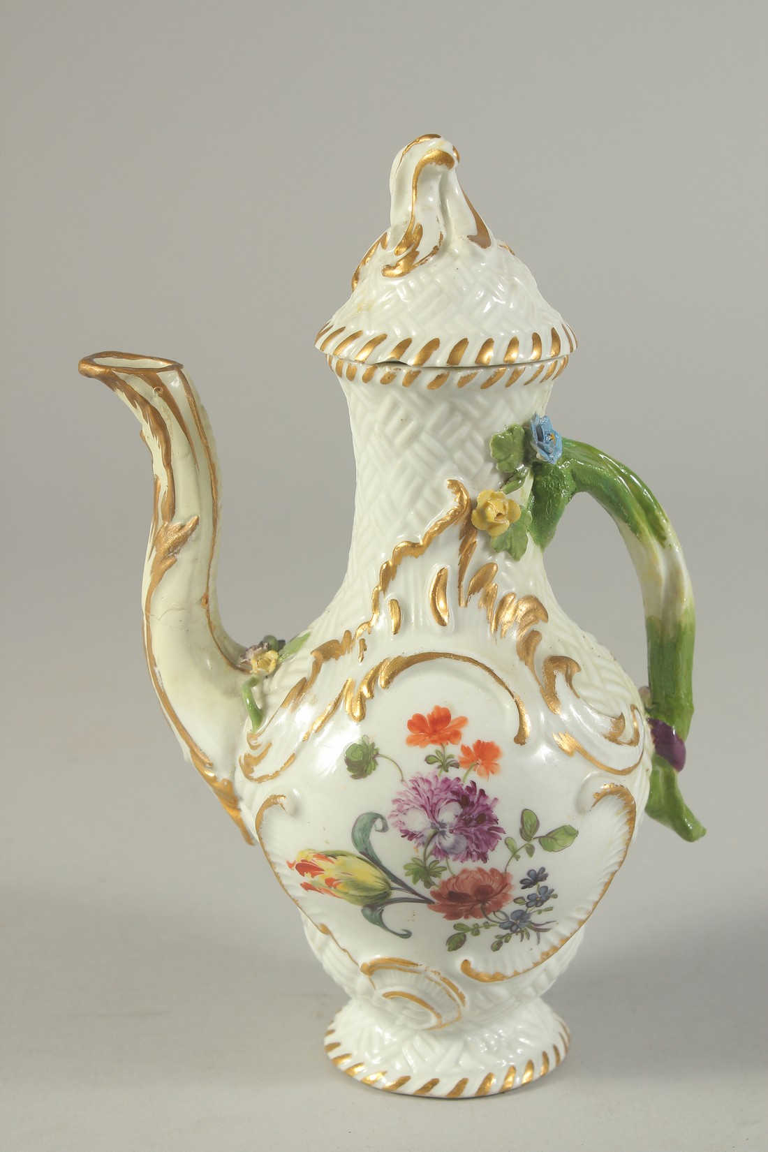 A SMALL MEISSEN PORCELAIN JUG AND COVER painted with flowers. Cross swords mark in blue. 6.5ins high