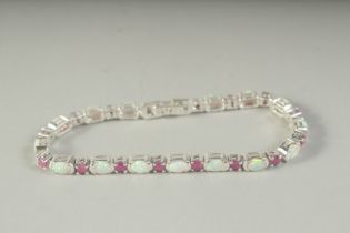 A SILVER OPAL AND RUBY LINE BRACELET, boxed.