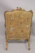 A FRENCH CARVED AND GILDED FIRE SCREEN with needlework panel. 3ft 6ins high, 2ft wide.