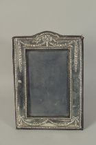 A SILVER PHOTOGRAPH FRAME with ribbons motif. 7.5ins x 5.5ins. London 1968.
