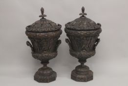 A GOOD LARGE PAIR OF URNS AND COVERS, POSSIBLY IRISH, carved with cupids and scrolls, with pineapple