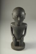 A CARVED TRIBAL FIGURE. 15ins high.