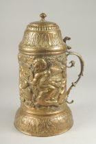 A GOOD LARGE METAL REPOUSSE FLAGON AND COVER with cupid design.