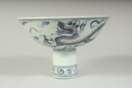 A CHINESE BLUE AND WHITE DRAGON DESIGN STEM CUP. 5.5ins diameter.