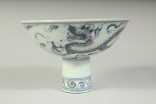 A CHINESE BLUE AND WHITE DRAGON DESIGN STEM CUP. 5.5ins diameter.