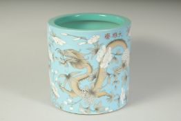 A CHINESE PORCELAIN CIRCULAR BRUSH POT painted with dragons.