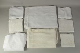 THREE WHITE EMBROIDERED TABLE CLOTHS with three sets of napkins.