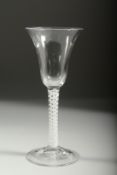 A GEORGIAN WINE GLASS with inverted bell bowl and white twist stem. 7ins high.
