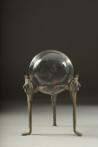 A CRYSTAL BALL, 3ins diameter, on a metal stand.