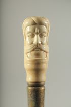 A WALKING STICK WITH CARVED BONE HANDLE "TURK".