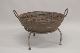 A CAST IRON FIRE PIT, circular with carrying handles, on a stand. 2ft diameter.